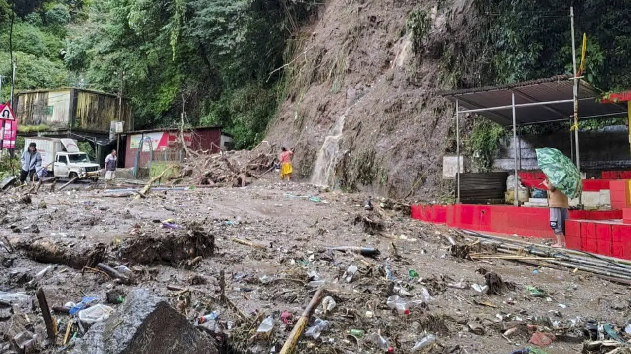 People look at the debris scattered around after heavy rainfall triggers landslides, in Darjeeling. (Pic credit: PTI) Landslides in Darjeeling