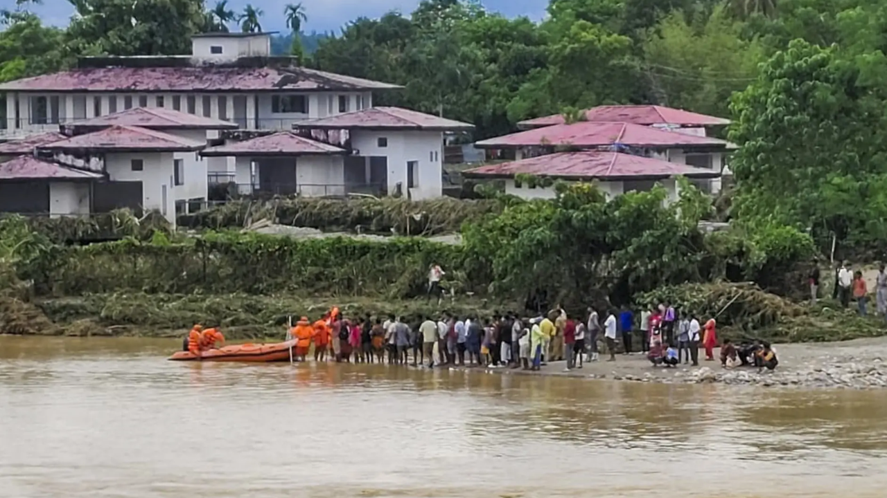 People gather along a shore after heavy rainfall triggers landslides, in Darjeeling. (Pic credit: PTI) Landslides in Darjeeling